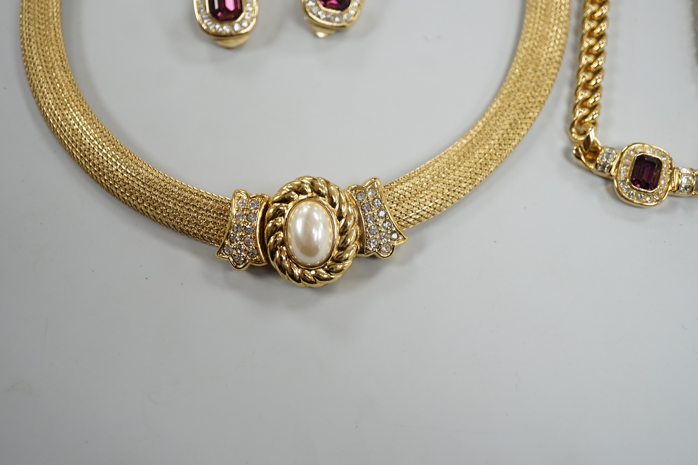 A modern Christian Dior gilt metal and two colour paste set necklace, 37cm and a pair of matching ear clips and one other Christian Dior necklace.
